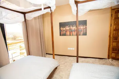 a bedroom with two bunk beds and a painting at Shibam Campsite in Naberera