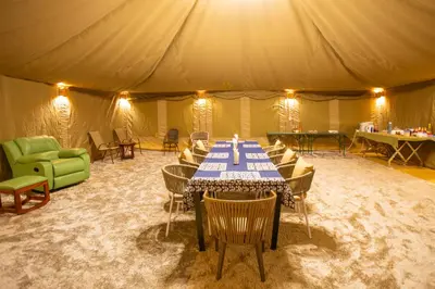 a tent with a table and chairs in it at Shibam Campsite in Naberera