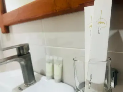 a kitchen counter with a glass cup next to a sink at Sunset Retreat Hotel in Arusha