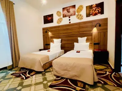 a hotel room with two beds in a room at Sunset Retreat Hotel in Arusha
