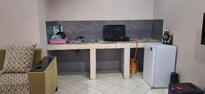 a kitchen with a desk with a computer on it at African Royal Homestay karatu in Karatu