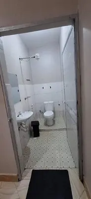a bathroom with a toilet and a sink at African Royal Homestay karatu in Karatu