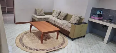 a living room with a couch and a coffee table at African Royal Homestay karatu in Karatu