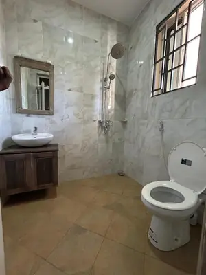 a bathroom with a toilet and a sink at Cj VILLA in Karatu