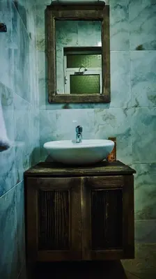 a bathroom with a sink and a mirror at Cj VILLA in Karatu