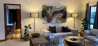 a living room with a couch and a table at Asama House in Usa