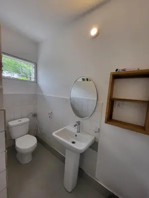 a bathroom with a toilet and a sink and a mirror at House, towncenter, near to all good restaurants, in Arusha