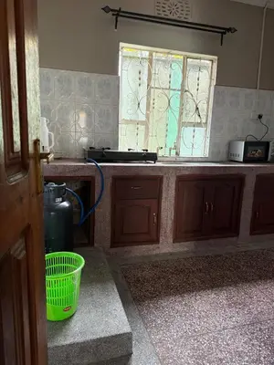a kitchen with a sink and a window and a basket at At Chilala's in Arusha