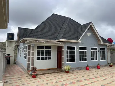 a house with a gray roof on a courtyard at Famurest in Nkoanrua