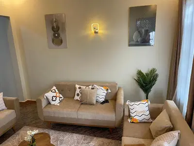 a living room with a couch and pillows at Famurest in Nkoanrua