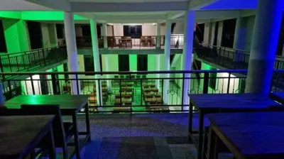 a room with green lights on a building with tables at Kilimanjaro Village Hotel