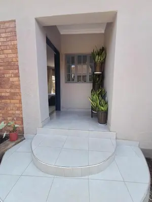 a lobby of a house with two plants at Casabella stay in Arusha