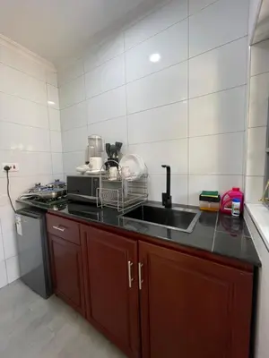 a kitchen with a sink and a microwave at Casabella stay in Arusha