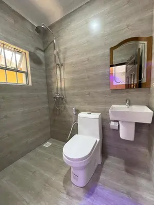 a bathroom with a toilet and a sink at Casabella stay in Arusha