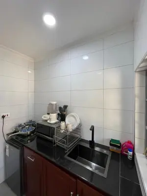 a kitchen with a sink and a microwave at Casabella stay in Arusha