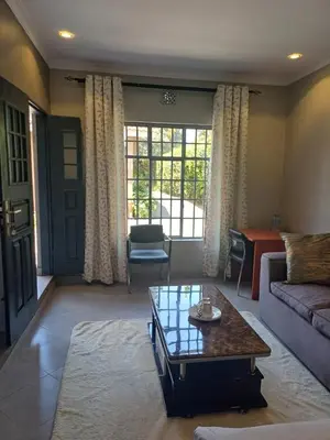 a living room with a couch and a coffee table at Casabella stay in Arusha