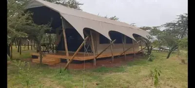 a tent sitting in a field in the grass at Summit Scape Adventures Safaris Limited in Arusha