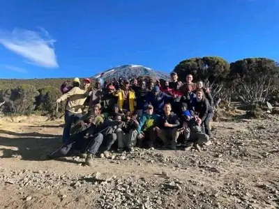a group of people posing for a picture on a mountain at Summit Scape Adventures Safaris Limited in Arusha