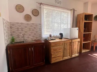 a kitchen with a sink and a microwave at John's Place in Arusha