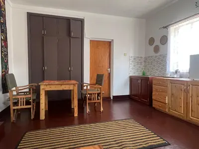a kitchen with a table and chairs in a room at John's Place in Arusha