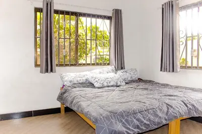 a bed in a room with a window at njiro one in Arusha