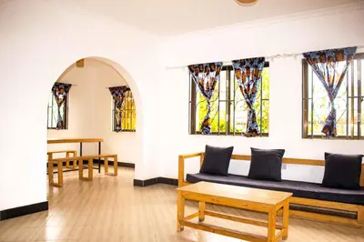 a living room with a couch and stained glass windows at njiro one in Arusha