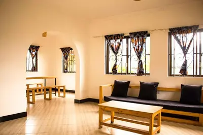 a living room with a couch and some windows at njiro one in Arusha