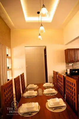 a dining room with a table with plates and napkins at The Luxe Homes 3BR Luxury Stay in Tuvaila