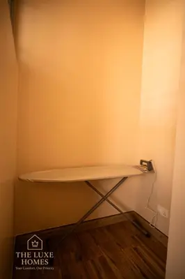 a shelf in the corner of a room at The Luxe Homes 3BR Luxury Stay in Tuvaila