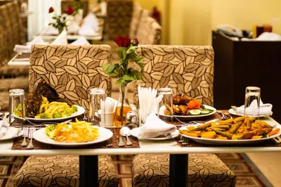 a table with three plates of food on it at Gold Crest Hotel - Arusha in Arusha