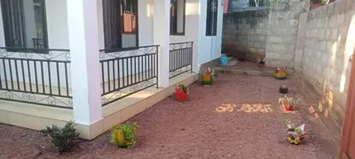 a porch of a house with some plants on the ground at Latricia Home Stay in Moshi