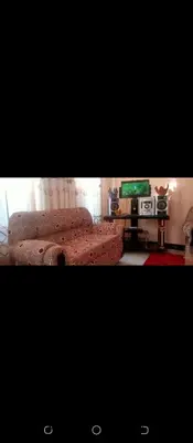 a living room with a couch and a tv at Latricia Home Stay in Moshi