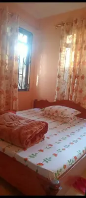 a bedroom with a bed with a blanket on it at Latricia Home Stay in Moshi