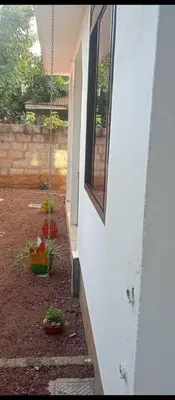 a house with a porch with flowers and a window at Latricia Home Stay in Moshi