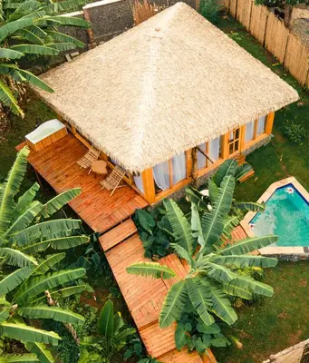 an aerial view of a house with a straw roof at Kilimani Villa in Moshi