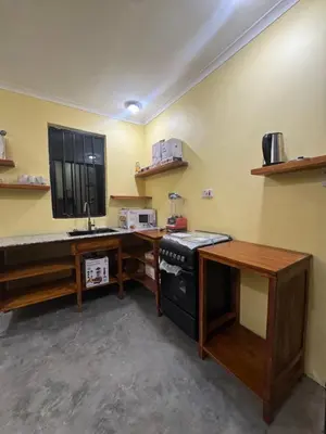 a kitchen with a counter and a stove and a desk at Kilimani Villa in Moshi