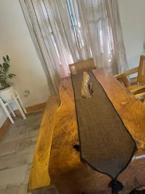 a wooden table with a cat sitting on top of it at Kienyeji Wooden Rest Arusha in Nkoanrua