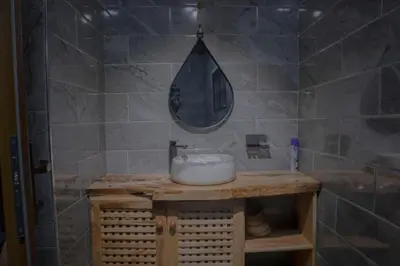 a bathroom with a sink and a mirror at Kienyeji Wooden Rest Arusha in Nkoanrua