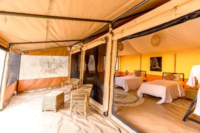 a room with two beds in a tent at Ndutu Bush Camp in Endulen