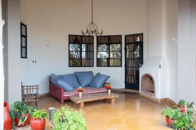 a living room with a couch and a fireplace at GreenNest Ranche in Arusha