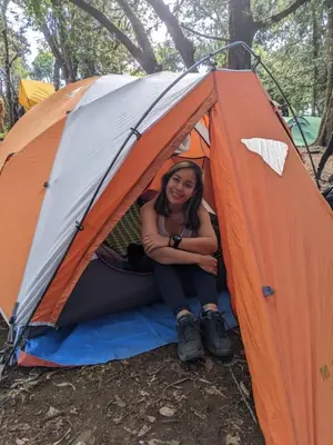 a woman sitting inside of a tent at Twende Africa Tours in Moshi