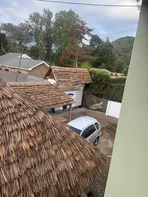 a car parked in front of a house with a roof at Woodland villa in Arusha