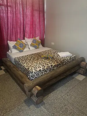 a bed in a room with a cheetah print at Woodland villa in Arusha