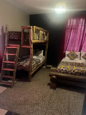 a room with two bunk beds and a lamp at Woodland villa in Arusha