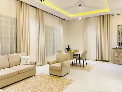 a living room with a couch and a table at Ellys home Arusha in Arusha