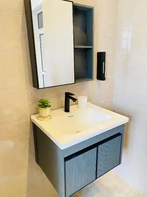 a bathroom with a sink and a mirror at Ellys home Arusha in Arusha