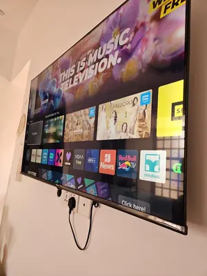 a flat screen tv hanging on a wall at Rest Stop Home in Arusha