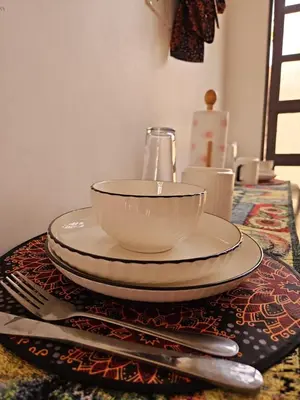 a table with a bowl and plates on a table at Rest Stop Home in Arusha