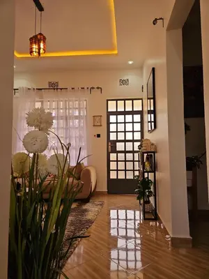 a living room with a couch and a window at Rest Stop Home in Arusha