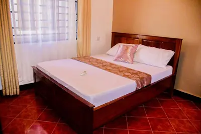 a bed in a small room with at Ezma-homes in Boma la Ngombe
